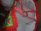 a bag of plastic water bottles and a bag of plastic water bottles on a table