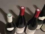 several bottles of wine are lined up on a table