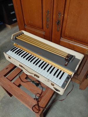 a piano that is sitting on a stand in a room