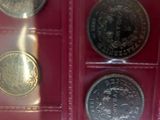 several different types of coins are in a display case