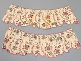 two pieces of cloth with floral designs on them on a blue surface