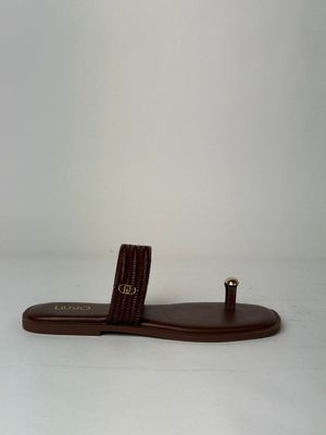 a close up of a pair of brown sandals on a white surface