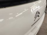 a close up of a white car with a sticker on it