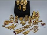 a bunch of gold jewelry sitting on top of a table