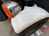 a scooter that has been covered with a sheet of paper
