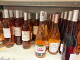 bottles of wine are lined up on a shelf in a store