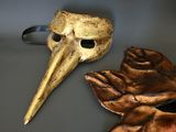 two masks that are sitting on a table