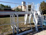a ladder that is next to a pool in a field