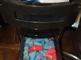 a drawer full of assorted items sitting on the floor