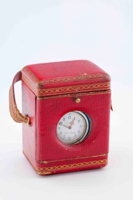 a small red box with a clock inside of it