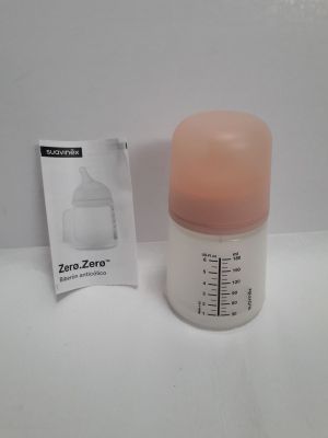 a bottle with a pink cap next to a packet of breast milk