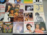a table topped with a lot of records and a record