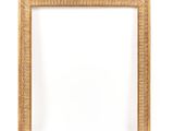 a gold frame on a white wall with a white background