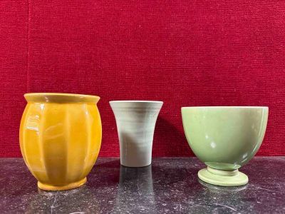 three vases sitting on a table next to each other