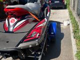 a red and black jet ski being pulled by a trailer