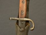a close up of a knife with a wooden handle on a black background