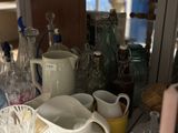 a lot of dishes and cups sitting on a table