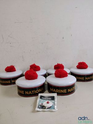 four red pom poms sitting on top of a white table
