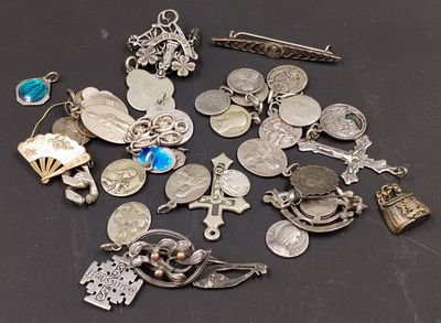 a lot of silver charms on a black surface