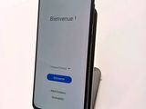 the back view of a smartphone with a blue button on it