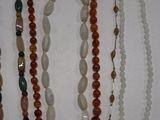 several necklaces of various shapes and sizes are displayed on a white surface