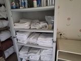a closet full of towels and other items in the room