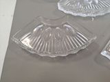 three clear glass dishes on a table with a silver tray