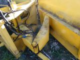 a yellow machine that is sitting in the grass