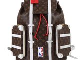 the backpack is brown and white with a red tag on it