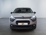 the front view of a silver citrole parked in a room