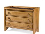a close up of a wooden dresser with three drawers