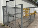 an image of a large metal fence in front of a building