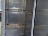 an open refrigerator that is sitting outside on the ground