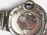 a close up of a watch on a white surface