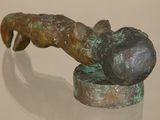a bronze statue of a person holding a ball