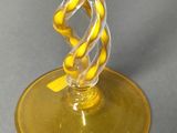 a glass that has a yellow ribbon on it
