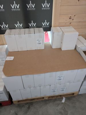 a large pile of boxes sitting on a pallet in a warehouse