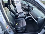 the interior of a car with the door open and the passenger seat down