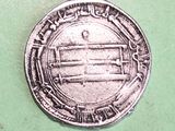 a close up of a coin on a green surface