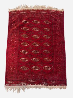 a red rug with fringes on a white background