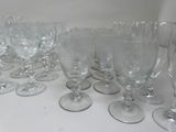 many empty wine glasses lined up on the table