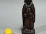 a small statue of a monk next to a yellow ball