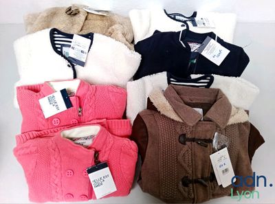 a lot of sweaters that are sitting on a table