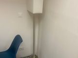 a blue chair and a white lamp in a small room