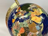 a blue and gold globe with a map on it