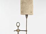 a lamp that is on a stand with a lamp shade on it