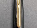 a black and gold fountain pen with a gold tip
