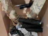 a cardboard box filled with assorted items including a pair of umbrellas