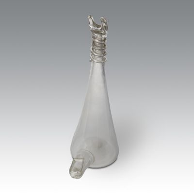 an image of a glass bottle with a handle on a white surface