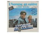 the poster for the movie l ' homme en coulee, with a man in a suit and woman